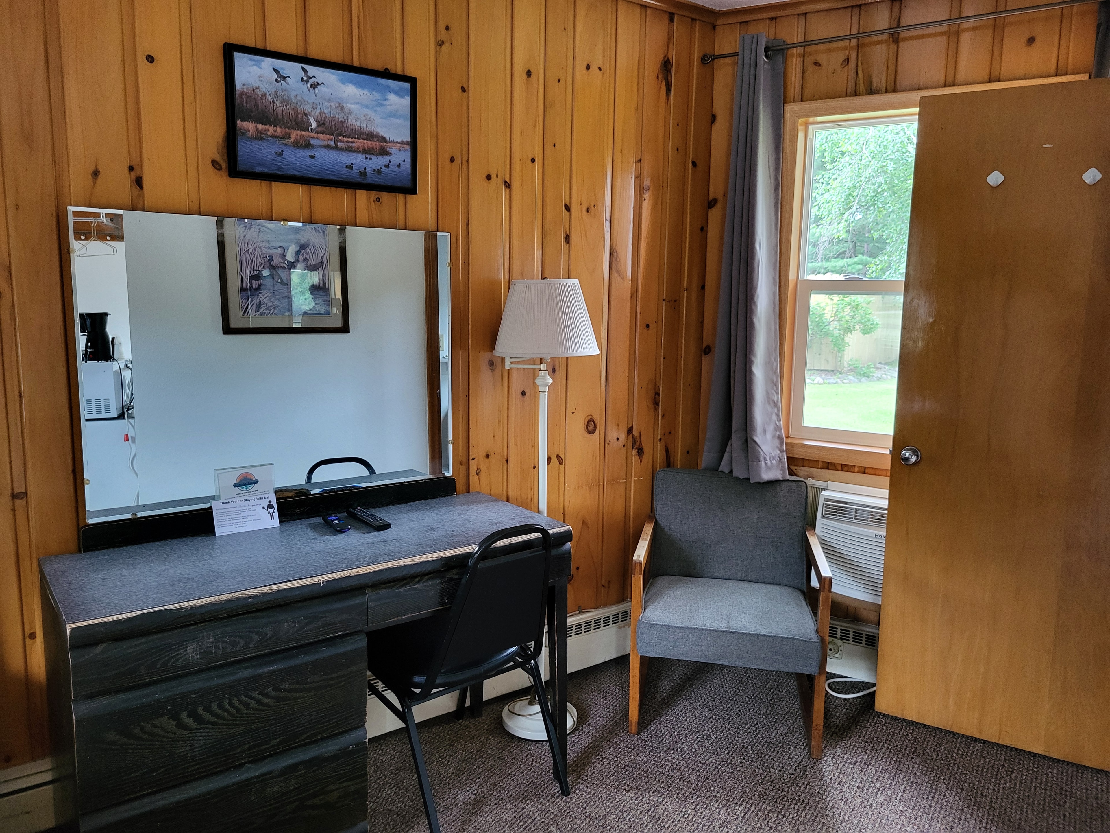 Clean motel bedroom with blue bedding